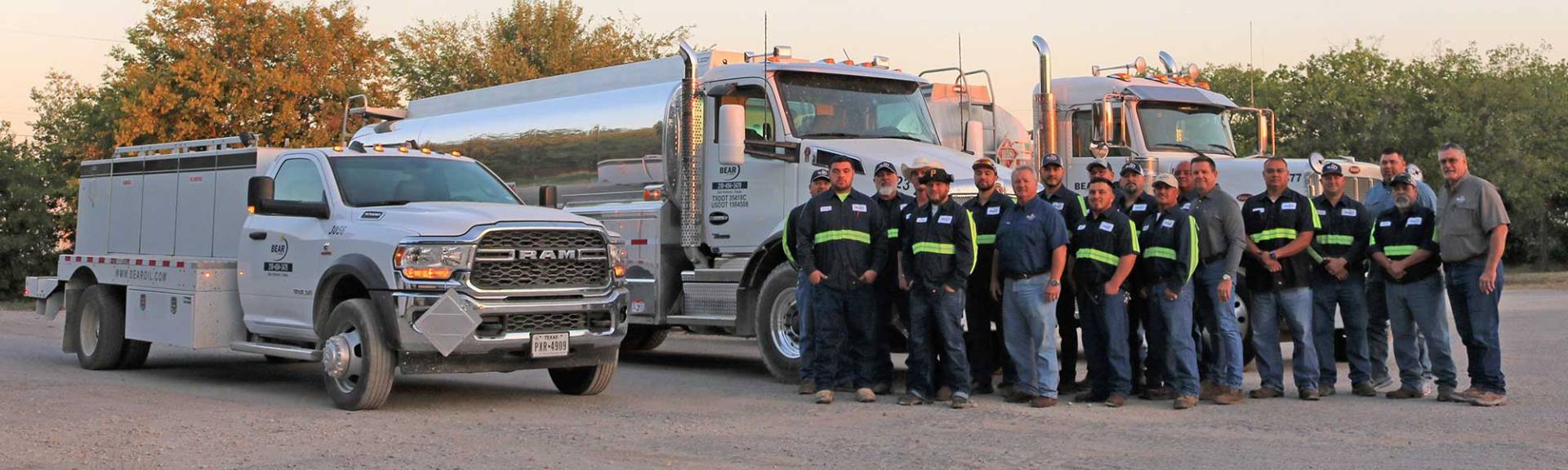 Bear Oil employees in front of trucks